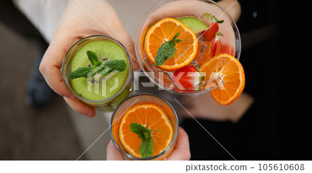 Top view of three different delicious cocktails with mint and juicy fruits Top view of three different delicious cocktails with mint and juicy fruits 105610608