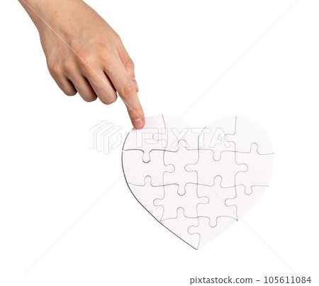 Completing fixing heart shaped puzzle isolated on white background. Love and family psychology concept 105611084