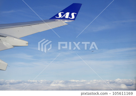 KOPENHAGEN, DENMARK - 24 NOV 2018: View from the aircraft cabin to the wing shortly after take-off 105611169