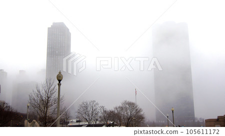 CHICAGO, ILLINOIS, UNITED STATES - DEC 12, 2015: Downtown Chicago skyscrapers in the fog on an overcast winter day 105611172