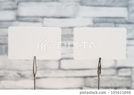 Two sheets of memo paper sandwiched between memo clips Two sheets of memo paper sandwiched between memo clips 105611698