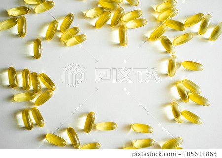 Fish oil supplement capsules on a white surface as a background. Oil filled capsules of food supplements. Fish oil, omega 3. 105611863