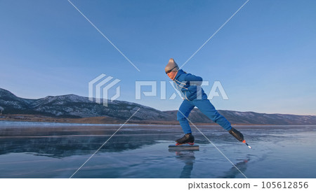 The child train on ice professional speed skating. The girl skates in the winter in sportswear, sport glasses, suit. Outdoor slow motion. The child train on ice professional speed skating. The girl skates in the winter in sportswear, sport glasses, suit. Outdoor slow motion. 105612856
