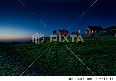 Houses on a picturesque hill overlooking the ocean. beautiful night scenery Houses on a picturesque hill overlooking the ocean. beautiful night scenery 105613011