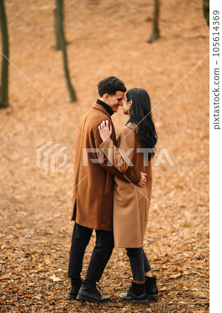 Young couple in love walking in the park on a autumn day. Enjoying time together. 105614369