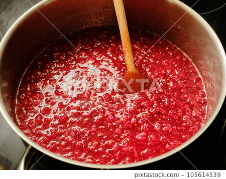 Cooking redcurrant berries preparing jam Cooking redcurrant berries preparing jam 105614539
