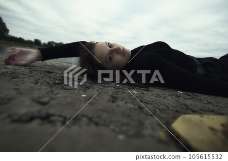 bullying teenage girl lies on the pier near the water upset and looks and thinks how hard help is needed. High quality photo 105615532