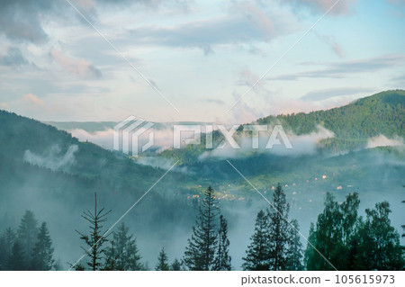Wonderful countryside with fog under sunlight. Fog over the mountains. Unsurpassed misty morning in the mountains during sunrise. Amazing nature scenery. Stunning alpine Landscape. Wonderful countryside with fog under sunlight. Fog over the mountains. Unsurpassed misty morning in the mountains during sunrise. Amazing nature scenery. Stunning alpine Landscape. 105615973