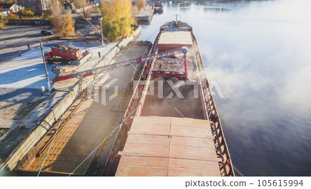 Loading wheat grain into barge, port and food industry grain silos in the port of Ukraine Loading wheat grain into barge, port and food industry grain silos in the port of Ukraine 105615994