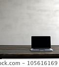 Laptop computer on wooden table with concrete wall background, stock photo 105616169