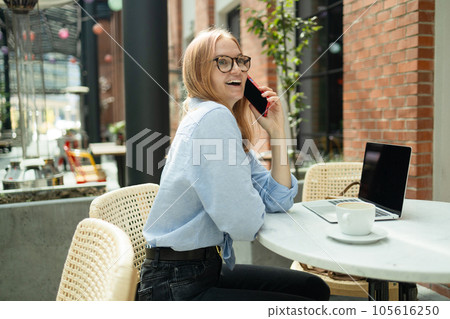 Businesswoman student calling with cell telephone while sitting alone in coffee shop during free time, attractive female with cute smile having talking conversation with mobile phone while rest in Businesswoman student calling with cell telephone while sitting alone in coffee shop during free time, attractive female with cute smile having talking conversation with mobile phone while rest in 105616250