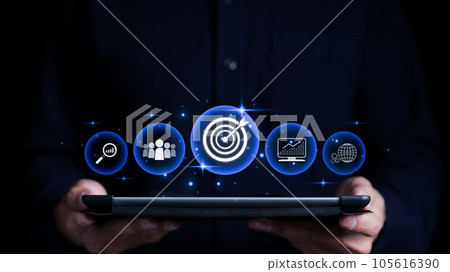 Targeting the business concept. Businessman holding tablet with business goal target icons on virtual screen. Technology and innovation theme. Digital marketing online, Project management, Aiming, Targeting the business concept. Businessman holding tablet with business goal target icons on virtual screen. Technology and innovation theme. Digital marketing online, Project management, Aiming, 105616390