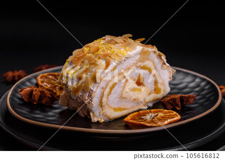Delicious, fresh, sweet meringue roll with cream, almond chips, nuts and berries 105616812