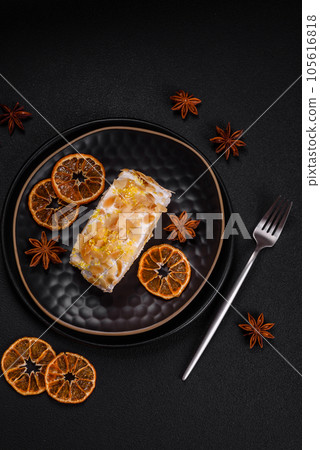 Delicious, fresh, sweet meringue roll with cream, almond chips, nuts and berries 105616818