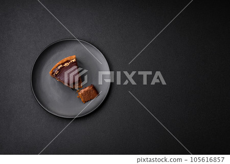 Delicious, fresh, sweet chocolate cake with nuts cut into slices 105616857