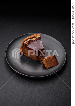 Delicious, fresh, sweet chocolate cake with nuts cut into slices 105616859