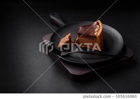 Delicious, fresh, sweet chocolate cake with nuts cut into slices 105616860