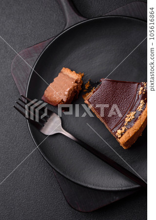 Delicious, fresh, sweet chocolate cake with nuts cut into slices 105616864