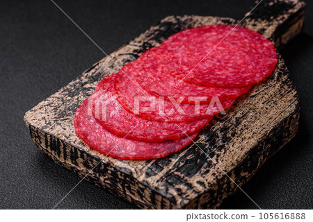 Delicious smoked salami sausage with salt, spices and herbs 105616888