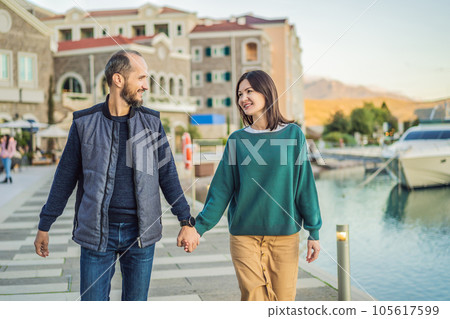 Couple in love tourists enjoying the views of Architecture and luxury yachts in Lustica Bay, Montenegro. Travel around Montenegro concept. Go Everywhere 105617599