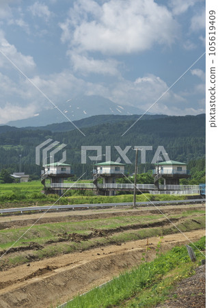 Takizawa headworks and Mt. Chokai in midsummer as seen from the Yuri Kogen Railway Takizawa headworks and Mt. Chokai in midsummer as seen from the Yuri Kogen Railway 105619409