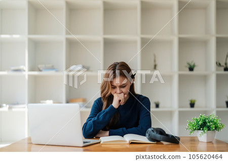 Tired asian woman bored with of laptop sad and frustrated about distance learning or online education sits at desk at home Tired asian woman bored with of laptop sad and frustrated about distance learning or online education sits at desk at home 105620464