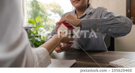 Property insurance, real estate broker or home insurance agent gesture protect house, contract document, security concept, protection. Insurance rent buy sell mortgage 105620468