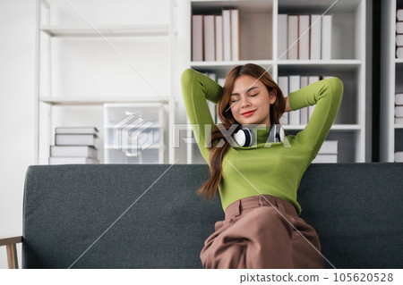 Beautiful young asian woman relieve herself feeling lazy, stretching on sofa and smiling pleased, relaxing at home, resting from work Beautiful young asian woman relieve herself feeling lazy, stretching on sofa and smiling pleased, relaxing at home, resting from work 105620528
