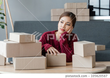 Young Asian business owner woman working with boring emotion. Online selling, SME entrepreneur, freelance working, work at from home concept 105620587