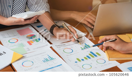 Business team analyzes financial business finance reports on laptop and graph documents during corporate meeting discussions showing successful teamwork, business meeting ideas 105620646