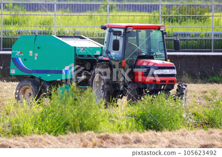 Straw roll work by tractor 105623492