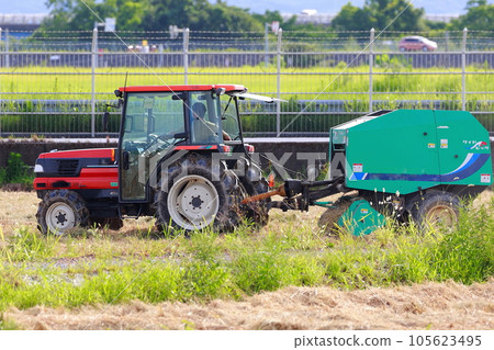 Straw roll work by tractor 105623495