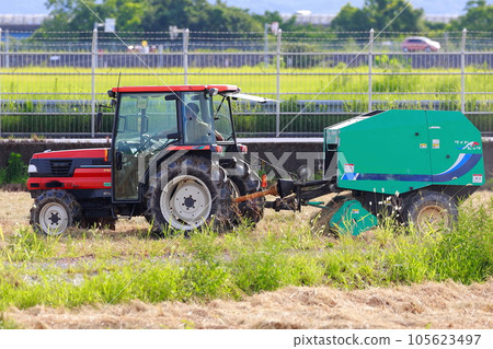 Straw roll work by tractor 105623497
