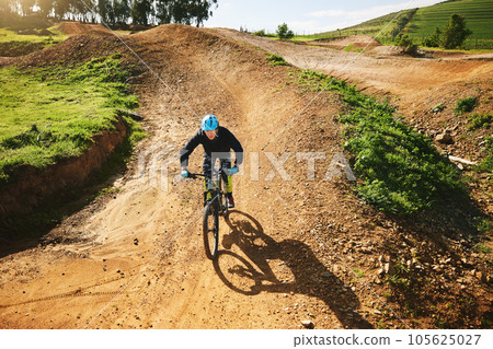 Cycling, sports and man in nature on bicycle for adrenaline on adventure, freedom and speed. Mountain bike, countryside and cyclist for training, exercise and fitness on dirt road, trail and track Cycling, sports and man in nature on bicycle for adrenaline on adventure, freedom and speed. Mountain bike, countryside and cyclist for training, exercise and fitness on dirt road, trail and track 105625027