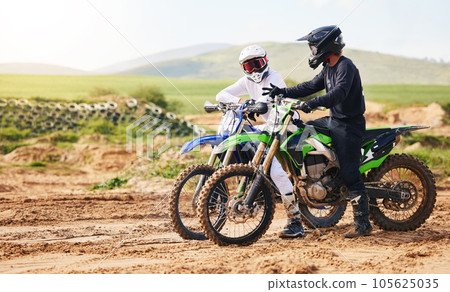 Sports, friends and men with motorcycle in countryside for fun, hobby and stunt training, practice or freedom. Off road on dirt, motorbike and biker people in nature for adrenaline, challenge or race 105625035