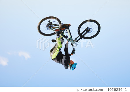 Bike, man and upside down in sky for action, bicycle stunt and challenge on mockup space. Biker, sports athlete and courage for air jump, energy and freedom of risk in cycling contest, race and show Bike, man and upside down in sky for action, bicycle stunt and challenge on mockup space. Biker, sports athlete and courage for air jump, energy and freedom of risk in cycling contest, race and show 105625641
