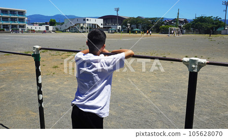 A boy watching the game in the schoolyard 105628070