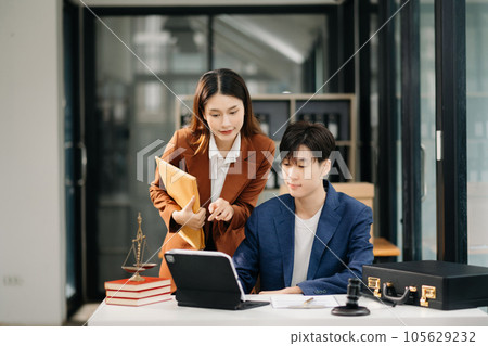 Asian business team and lawyers discussing contract papers sitting at the table. Concepts of law, advice, legal services. at office 105629232