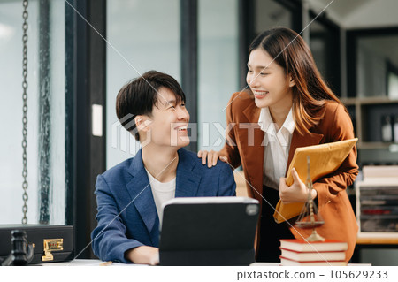 Asian business team and lawyers discussing contract papers sitting at the table. Concepts of law, advice, legal services. at office 105629233