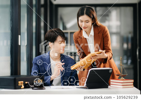 Asian business people and lawyers discussing contract papers sitting at the table. Concepts of law, advice, legal services. with VR icon 105629239