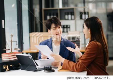 Asian business team and lawyers discussing contract papers sitting at the table. Concepts of law, advice, legal services. at office Asian business team and lawyers discussing contract papers sitting at the table. Concepts of law, advice, legal services. at office 105629319