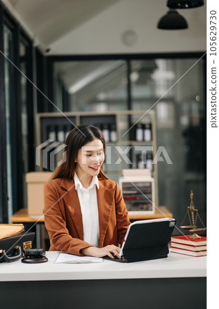 Asian man lawyer working and gavel, tablet, laptop in front, Advice justice and law concept.. 105629730