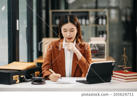 Asian man lawyer working and gavel, tablet, laptop in front, Advice justice and law concept.. 105629731