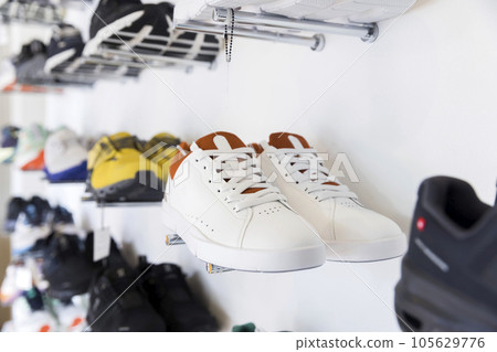 Sneakers lined up in a shoe shop Sneakers lined up in a shoe shop 105629776
