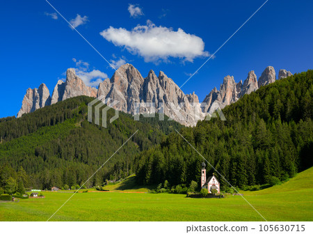 St Johann Church with landscape view of dolomites mountain peaks and blue sky, Santa Magdalena alpine village, Italy St Johann Church with landscape view of dolomites mountain peaks and blue sky, Santa Magdalena alpine village, Italy 105630715