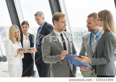 Business team discussing documents Business team discussing documents 105631909