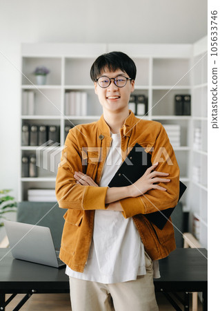 Handsome Asian business woman typing laptop and tablet Placed at the table at the modern office. 105633746