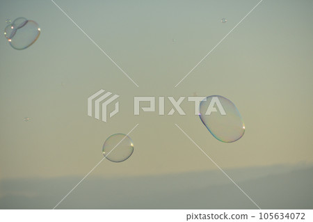 Sunset sky and soap bubbles Sunset sky and soap bubbles 105634072