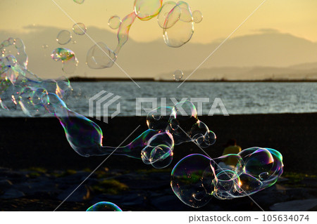Sunset sky and soap bubbles Sunset sky and soap bubbles 105634074