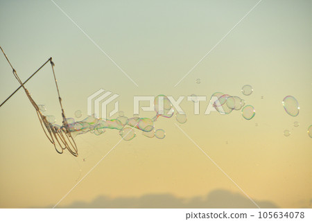 Sunset sky and soap bubbles Sunset sky and soap bubbles 105634078